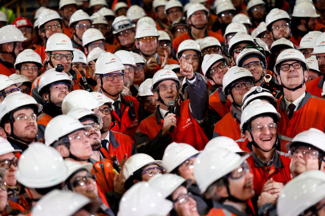 France's President Emmanuel Macron delivers a speech surrounded by employees during a visit to the new production lines at ArcelorMittals's new electric steel manufacturing facility in Mardyck, France, on Feb. 10, 2026. (Benoit Tessier/POOL/AFP via Getty Images)
