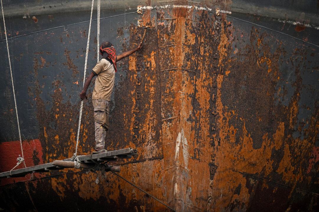 A worker repairs a ship at a dockyard on the outskirts of Dhaka, Bangladesh, on Feb. 10, 2026. Bangladesh's election campaign ended on Feb. 9, ahead of this week's vote, with rival parties invoking the 2024 uprising that ended the autocratic rule of Sheikh Hasina. (Sajjad Hussain/AFP via Getty Images)