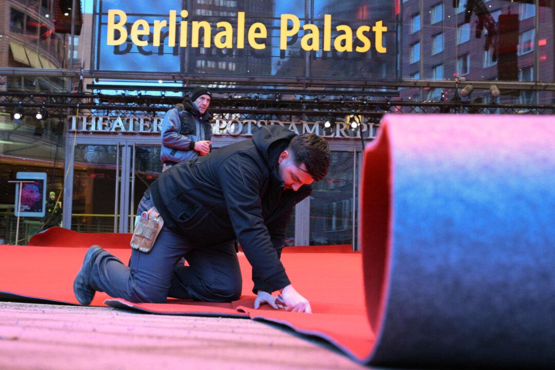 Workers lay the red carpet in front of the Berlinale Palace as preparations are under way for the 76th Berlinale, Europe's first major film festival of the year, in Berlin, on Feb. 10, 2026. (Ralf Hirschberger/AFP via Getty Images)