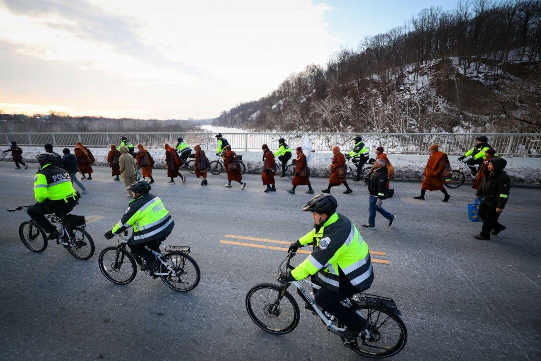 Buddhist monks continue their March for Peace as they cross Chain Bridge over the Potomac River between Arlington, Va., and Washington on Feb. 10, 2026. A group of 18 monks began their march to raise awareness of “peace, loving kindness, and compassion” in the United States and the world on Oct. 26 in Fort Worth, Texas, and will arrive in the nation's capital tomorrow. (Win McNamee/Getty Images)