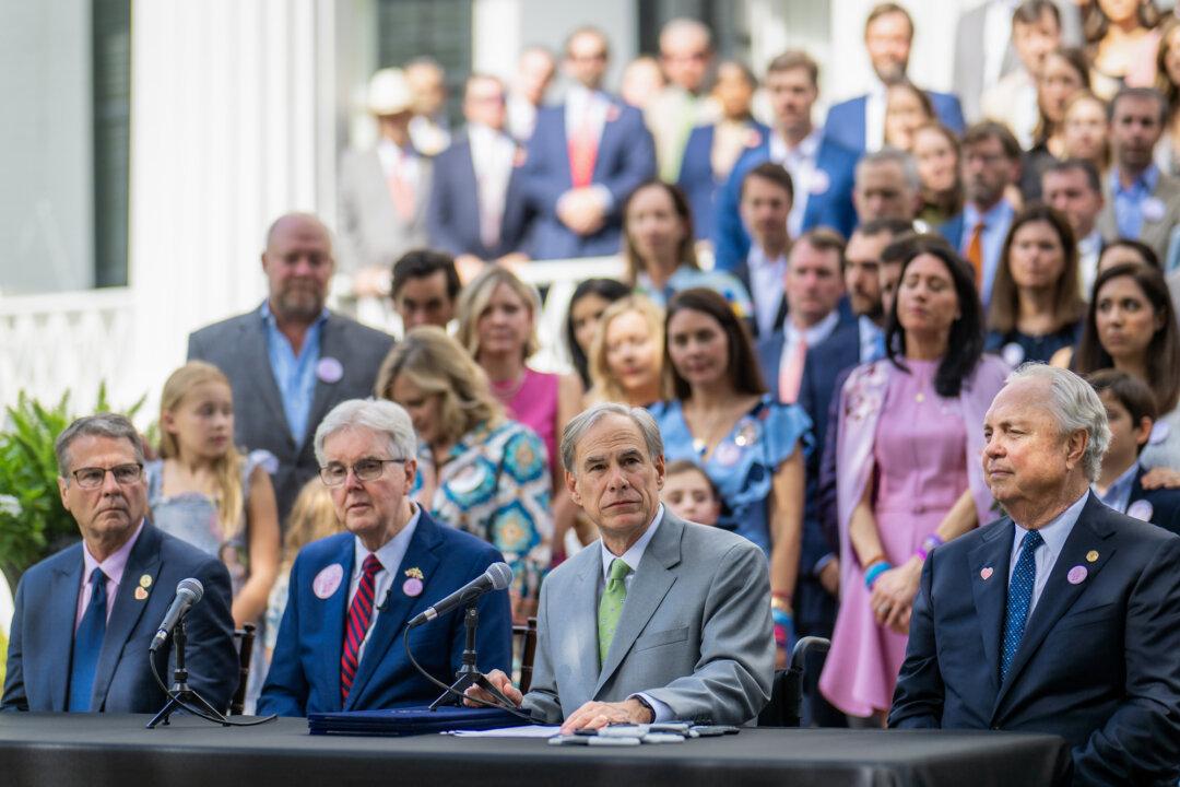 (L–R) Texas state Sen. Charles Perry, Lt. Gov. Dan Patrick, Gov. Greg Abbott, and state Rep. Drew Darby host a bill ceremony at the Texas Governor’s Mansion in Austin on Sept. 5, 2025. Texas schools, staff, and students face consequences for walkouts, after Abbott’s order to the Texas Education Agency to investigate alleged “inappropriate political activism” in public schools. (Brandon Bell/Getty Images)