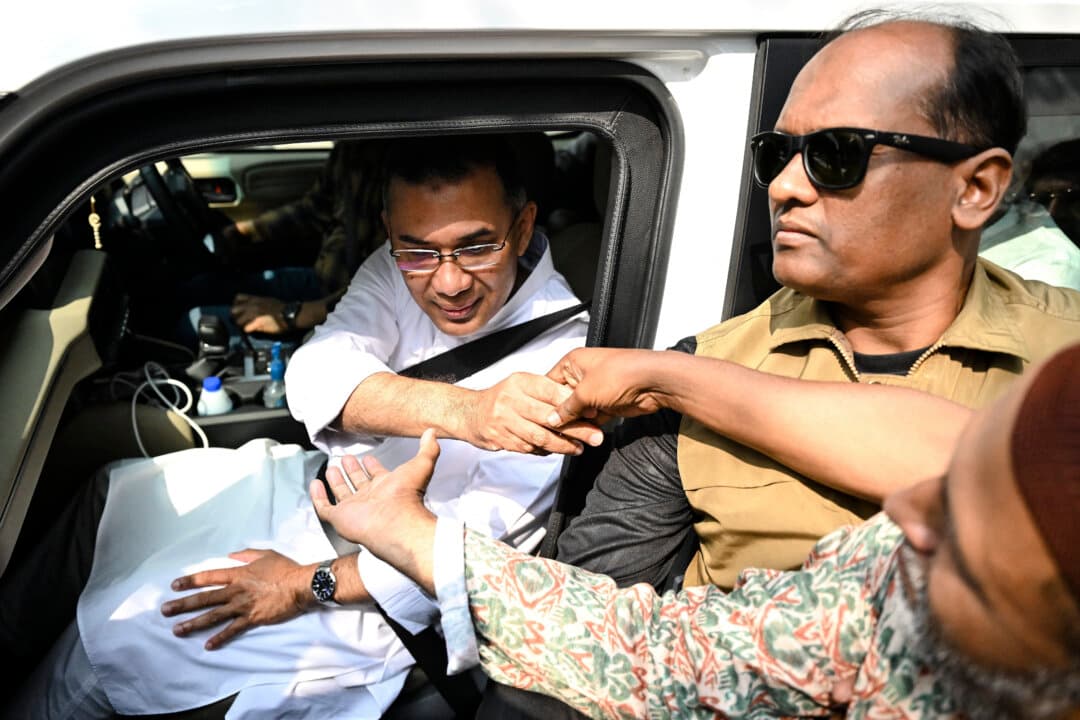 Bangladesh Nationalist Party (BNP) chairman and election candidate Tarique Rahman greets supporters as he leaves his residence in Dhaka, Bangladesh, on Feb. 13, 2026, a day after the general election. The BNP won easily in the first elections held since a deadly 2024 uprising, with leader Tarique Rahman poised to become prime minister. (Munir Uz Zaman/AFP via Getty Images)