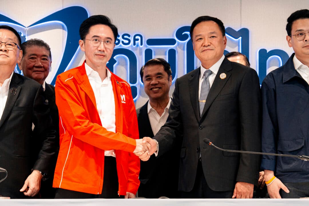 Thailand's caretaker Prime Minister Anutin Charnvirakul (C-R), leader of the Bhumjaithai party, shakes hands with the Pheu Thai Party's prime ministerial candidate Yodchanan Wongsawat (C-L) during a meeting at Bhumjaithai headquarters in Bangkok, on Feb. 13, 2026. Charnvirakul said that his Bhumjaithai party, which won the election at the weekend, agreed to form a coalition with jailed Thai ex-premier Thaksin Shinawatra's party. (Arnun Chonmahatrakool/THAI NEWS PIX/AFP via Getty Images)