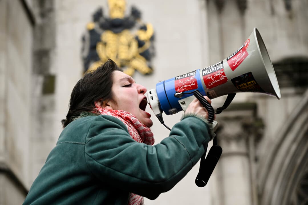 Demonstrators gather outside the High Court in London, on Feb. 13, 2026, during a ruling in which the court found that the government's ban of Palestine Action was unlawful. The ban, which took effect July 5 last year, made membership in or support for the direct-action group a criminal offense punishable by up to 14 years in prison. The move drew widespread condemnation and triggered protests during which more than 2,000 people were arrested. (Ben Montgomery/Getty Images)