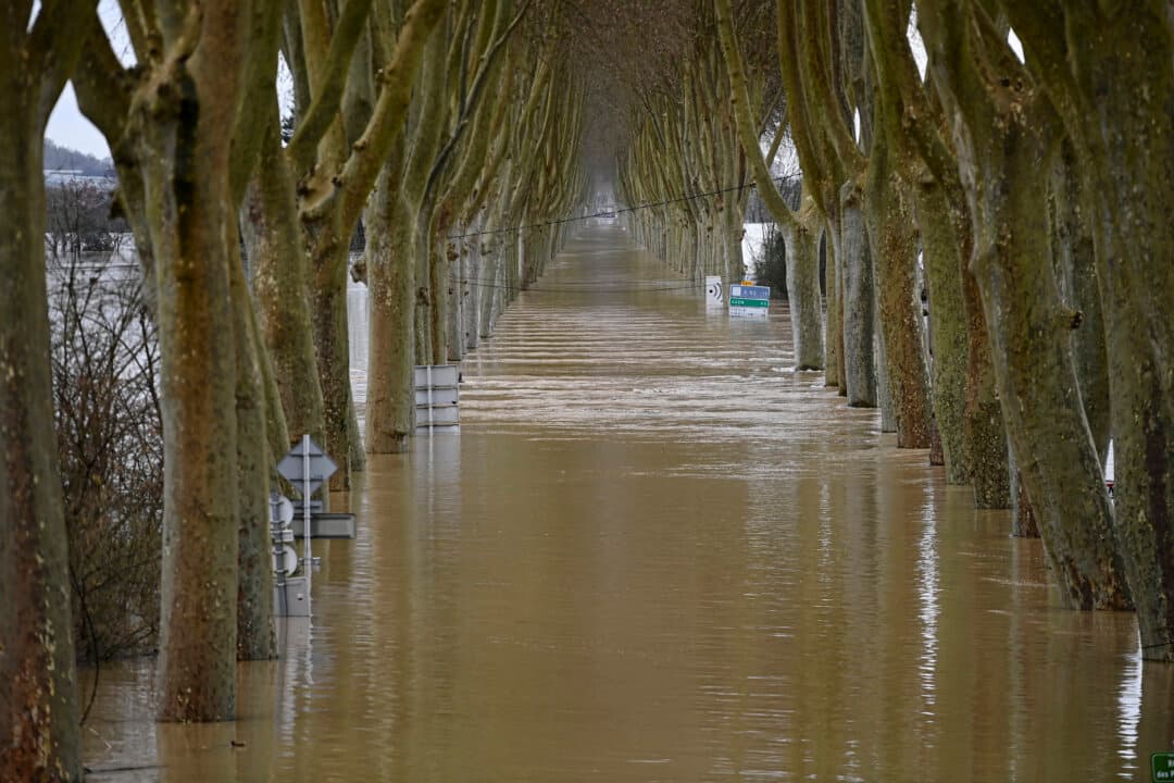 The overflowing Garonne river inundates a road in Tonneins, France, on Feb. 13, 2026. Storm Nils swept across the country for two days, claiming two lives, according to the government in the southwest, where a red alert remains in place. (Christophe Archambault/AFP via Getty Images)