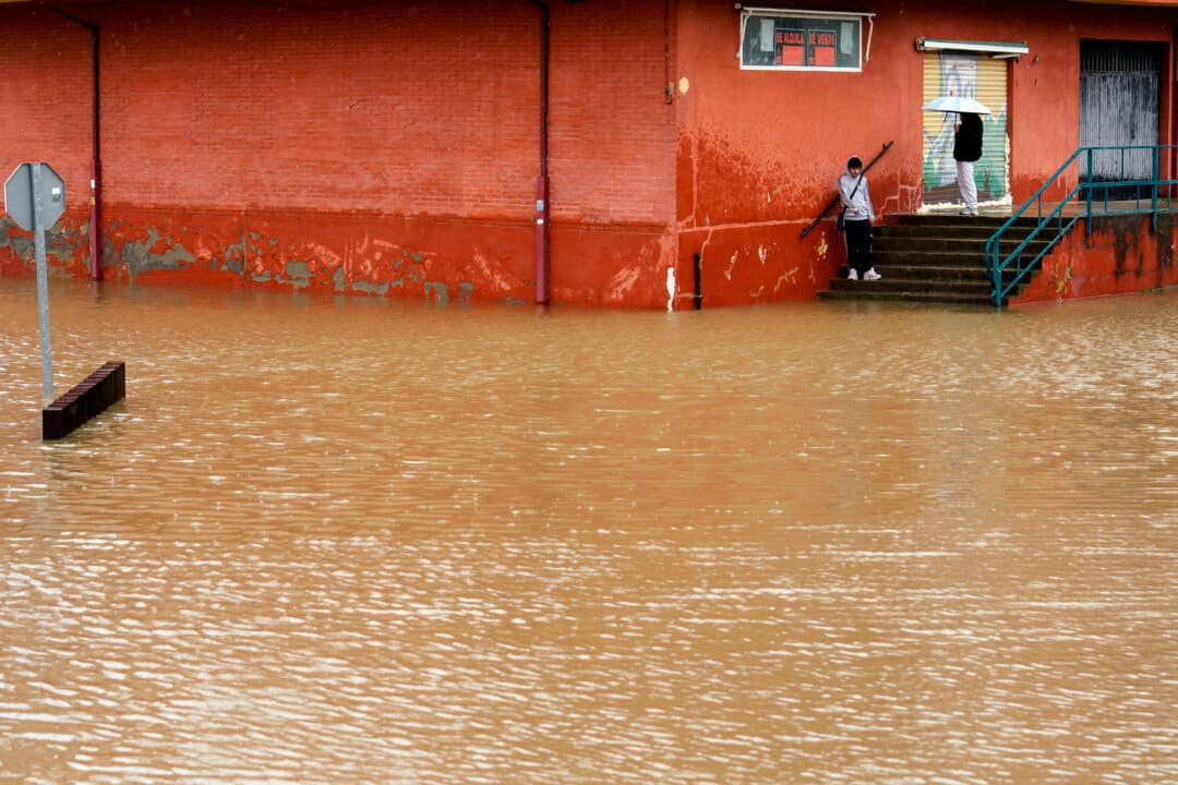 People observe floodwaters covering a street of Viana de Cega in the northern Spanish province of Valladolid, after the Cega river overflowed on Feb. 13, 2026. The latest storm comes as most of Spain was placed on alert for Storm Oriana, which is sweeping across the country with strong winds, heavy rain, snow in some areas, and rough seas expected. (Cesar Manso/AFP via Getty Images)