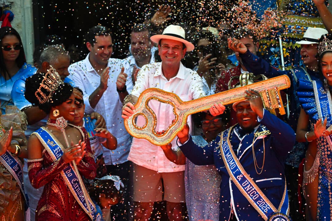 King Momo Cedric da Costa (R) receives the key of the city from Rio de Janeiro Mayor Eduardo Paes (C) during the official Carnival opening ceremony in Rio de Janeiro, Brazil, on Feb. 13, 2026. (Mauro Pimentel/AFP via Getty Images)