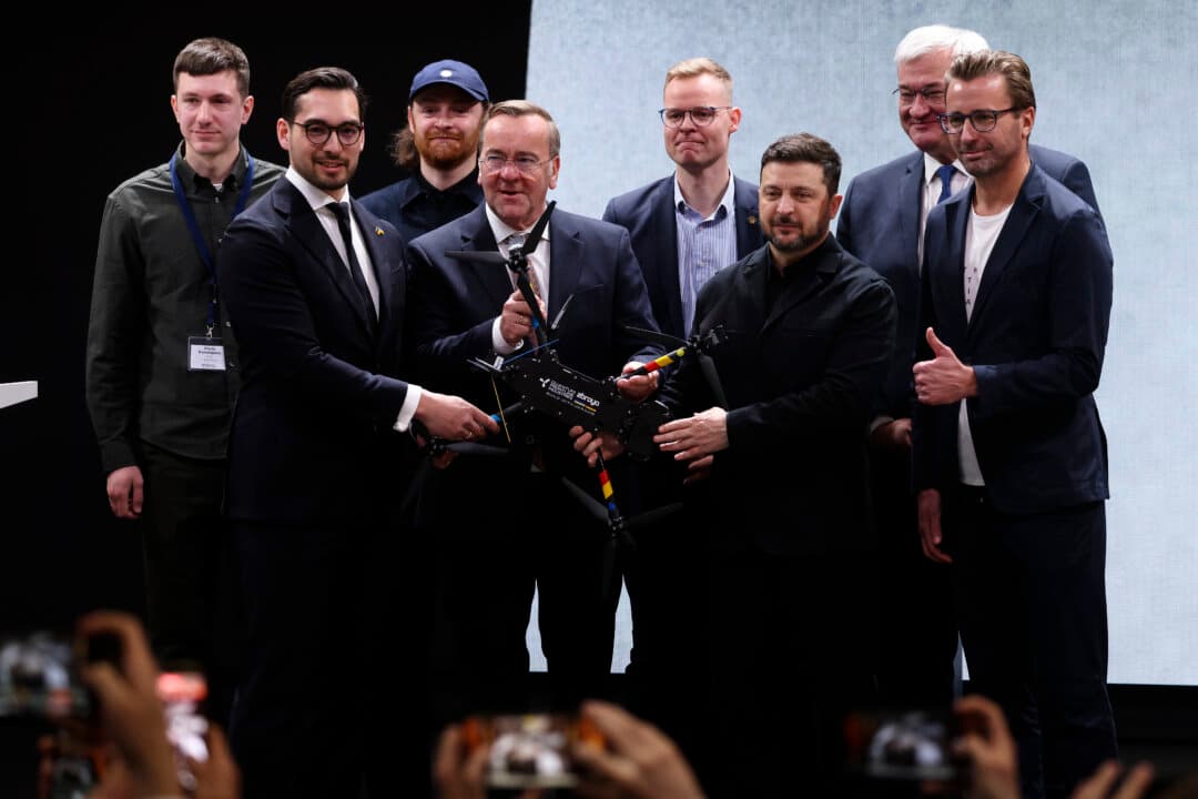 Ukrainian President Volodymyr Zelenskyy (C-R) and German Defense Minister Boris Pistorius (C) hold a Linza drone while visiting the production facility of Quantum Frontline Industries (QFI) near Munich, Germany, on Feb. 13, 2026. Quantum Frontline is a joint venture between Germany's Quantum Systems and Ukraine's Frontline Robotics under the “Build with Ukraine” initiative to produce Linza drones for the Ukrainian military. Zelenskyy is in Bavaria to attend the 62nd Munich Security Conference. (Sean Gallup/Getty Images)
