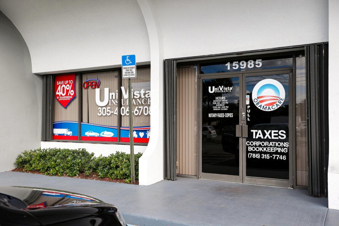 An Obamacare logo is shown on the door of the Univista Insurance agency in Miami on Jan. 10, 2017. Since the program started in 2014, federal cost-sharing reduction payments grew to more than $5.8 billion in 2017. (Rhona Wise/AFP via Getty Images)