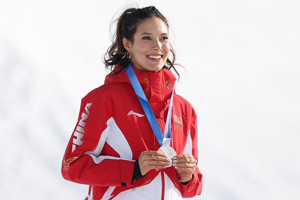 Silver medalist Ailing Eileen Gu of Team People's Republic of China celebrates on the podium after the women's slopestyle final on day three of the 2026 Winter Olympics at Livigno Snow Park in Livigno, Italy, on Feb. 9, 2026. (Michael Reaves/Getty Images)