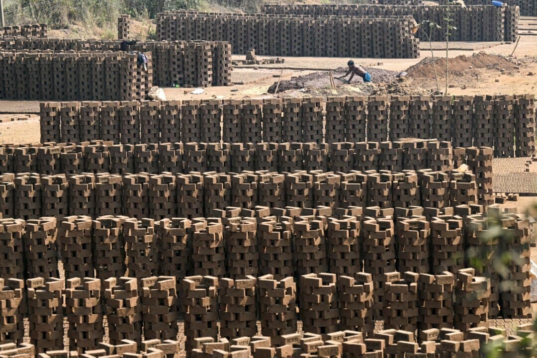A man works at a brick-kiln in the Gadade village of Palghar district, Maharashtra, India, on Feb. 14, 2026. (Indranil Mukherjee/AFP via Getty Images)