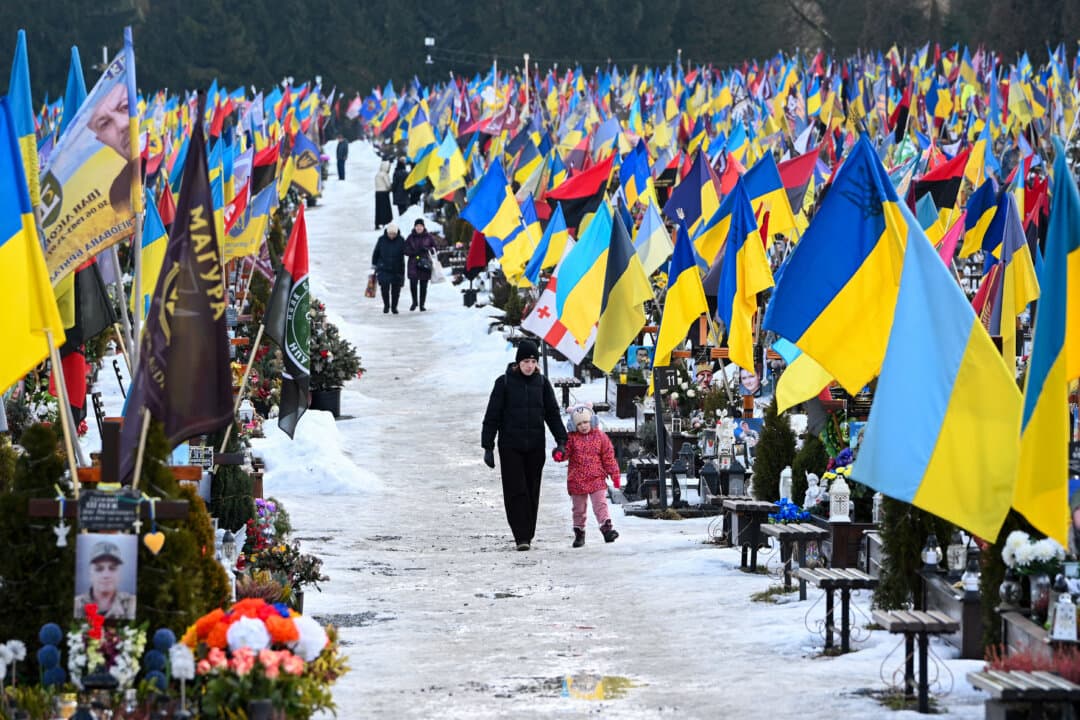Mourners walk on Valentine's Day at the Lychakiv Military Cemetery in Lviv, Ukraine, on Feb. 14, 2026. (Yuriy Dyachyshyn/AFP via Getty Images)