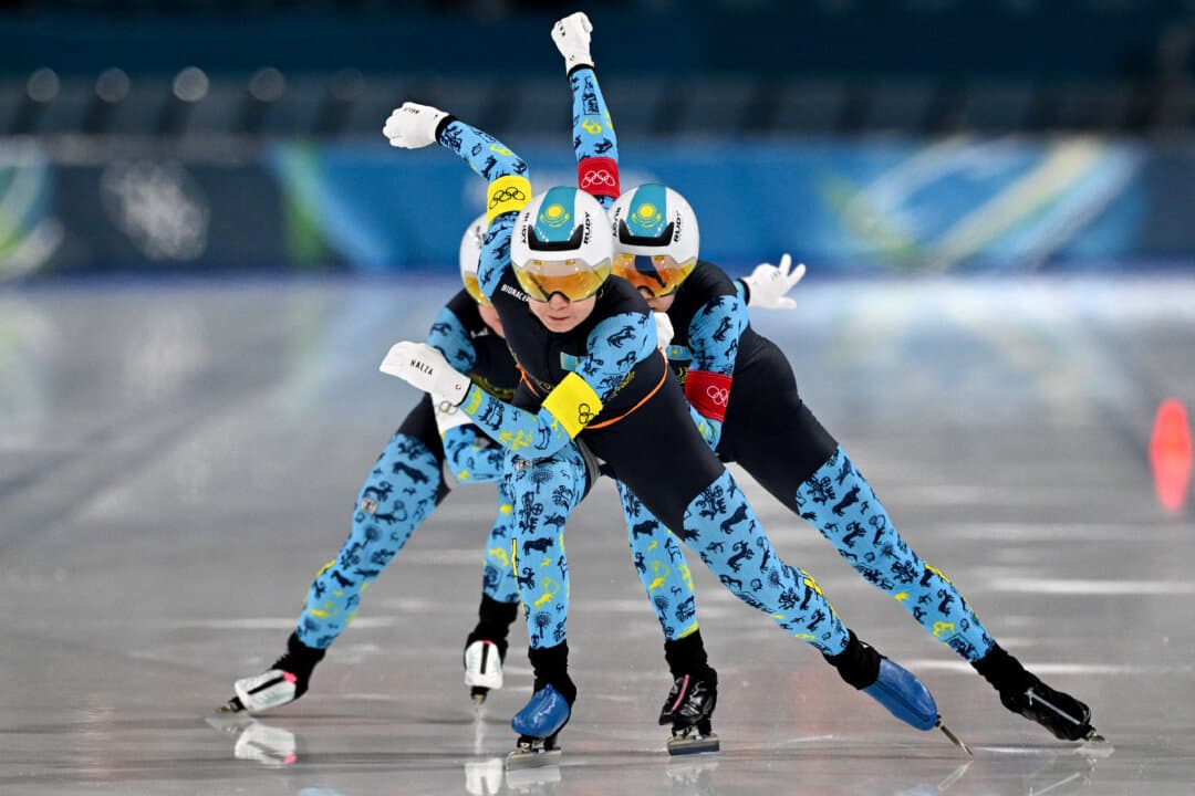 Kazakhstan's Nadezhda Morozova (front), Kazakhstan's Arina Ilyachshenko (R), and Kazakhstan's Elizaveta Golubeva compete in the speed skating women's team pursuit quarter-final during the Milano Cortina 2026 Winter Olympic Games at Milano Speed Skating Stadium in Milan, Italy, on Feb. 14, 2026. (Daniel Munoz/AFP via Getty Images)