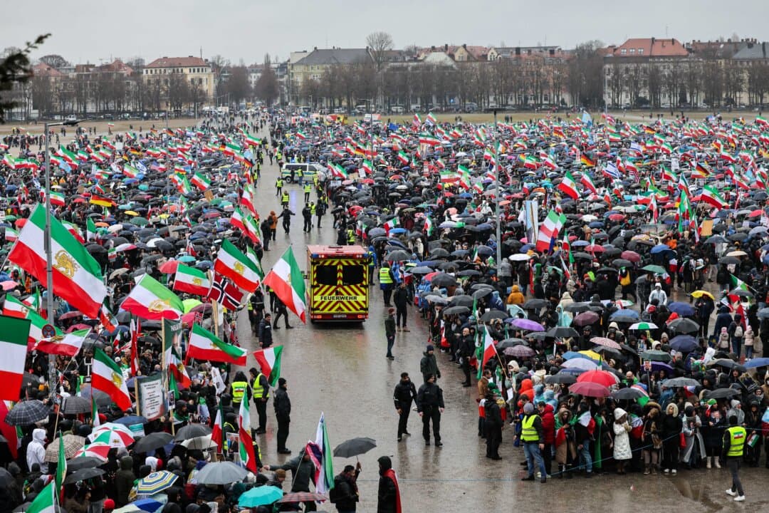 Hundreds of demonstrators with flags and umbrellas attend a demonstration of the Iranian opposition at the Theresienwiese fair grounds in Munich, Germany, on Feb. 14, 2026, on the sidelines of the 62nd Munich Security Conference. (Alexandra Beier/AFP via Getty Images)