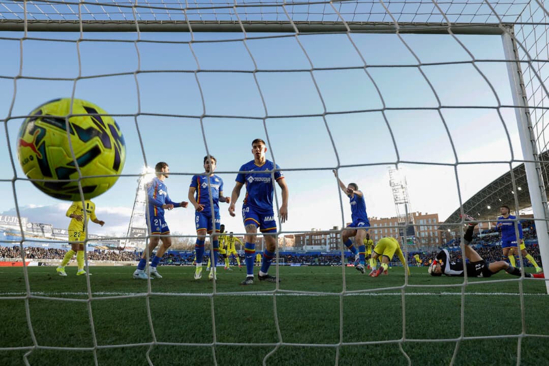 Getafe's Spanish goalkeeper #13 David Soria (2nd R) gets injured as Villarreal's French forward #09 Georges Mikautadze (3rd R) scores a goal during the Spanish league football match between Getafe CF and Villarreal CF at Coliseum Alfonso Perez Stadium in Getafe, Spain, on Feb. 14, 2026. (Oscar Del Pozo/AFP via Getty Images)