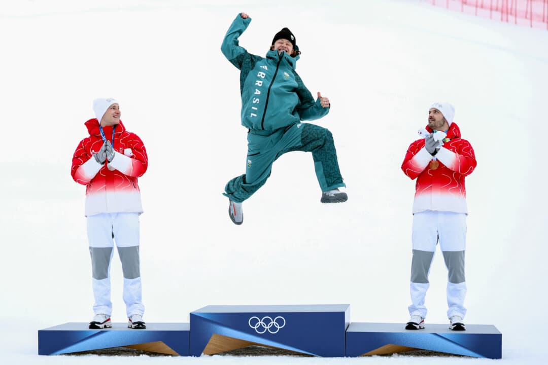 Gold medalist Lucas Pinheiro Braathen of Team Brazil, silver medalist Marco Odermatt of Team Switzerland, and bronze medalist Loic Meillard of Team Switzerland celebrate on the podium for the Men's Giant Slalom Run 2 on day eight of the Milano Cortina 2026 Winter Olympics at Stelvio Alpine Skiing Centre in Bormio, Italy, on Feb. 14, 2026. (Dustin Satloff/Getty Images)