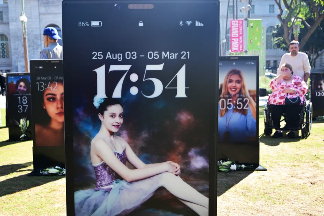 Images of deceased children are displayed at the “Lost Screen Memorial,” an art installation of large-scale smartphones featuring 50 children who lost their lives due to online harm, in Los Angeles on Feb. 13, 2026. Meta and Google-owned YouTube were accused on Feb. 9 of pushing highly addictive apps on children as a landmark social media trial began in a California court. The trial could establish a legal precedent on whether the social media juggernauts deliberately designed their platforms to lead to addiction in children. (Frederic J. Brown/AFP via Getty Images)