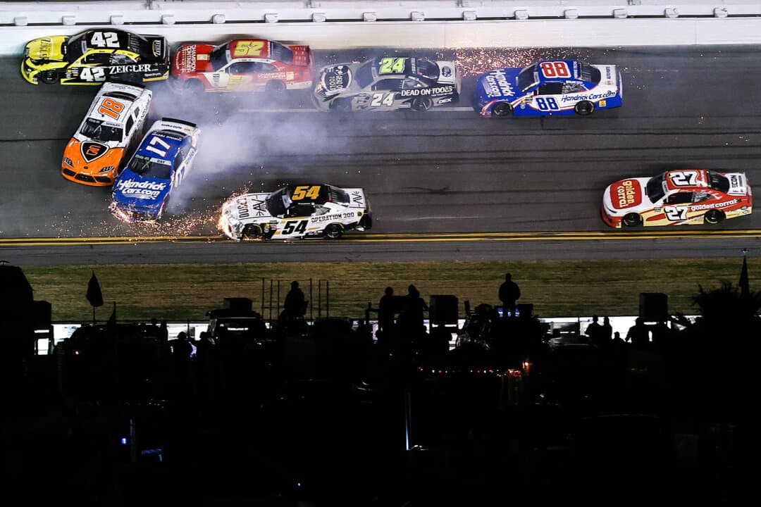 Taylor Gray, driver of the No. 54 Operation 300 Toyota; Corey Day, driver of the No. 17 HendrickCars.com Chevrolet; and William Sawalich, driver of the No. 18 Soundgear Toyota, spin after an on-track incident during the NASCAR O’Reilly Auto Parts Series United Rentals 300 at Daytona International Speedway in Daytona Beach, Fla., on Feb. 14, 2026. (Kevin C. Cox/Getty Images)