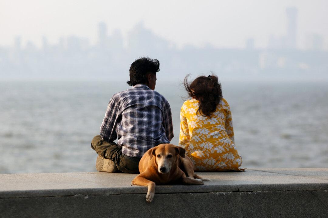 People enjoy the view and ocean breeze at the Marine Drive in Mumbai, India, on Feb. 16, 2026. (Ludovic Marin/AFP via Getty Images)