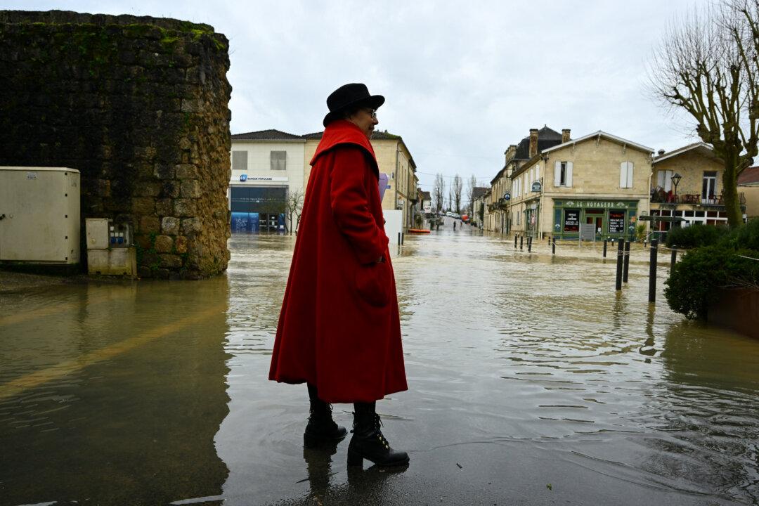 Minister for Ecological Transition and Biodiversity Monique Barbut stands in a flooded street as she visits Cadillac-sur-Garonne, France, on Feb. 16, 2026. France's flood alert system has been working at a record pace as relentless rain over the past month has saturated soils, the head of the agency told AFP. (Gaizka Iroz/AFP via Getty Images)