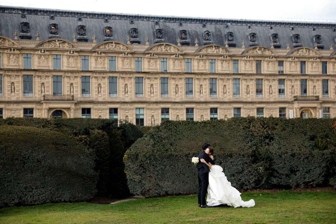 Newlyweds embrace at the Jardin des Tuileries, Paris, on Feb. 16, 2026. (Charlotte Siemon/AFP via Getty Images)