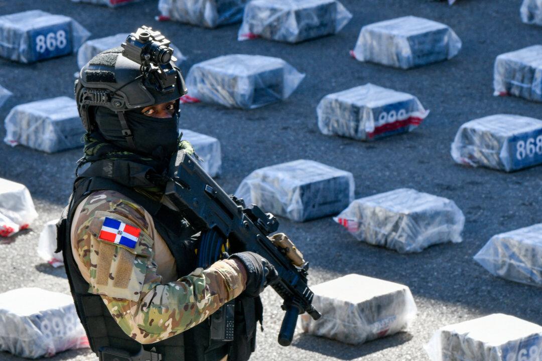A member of the National Drug Control agency stands guard next to seized packages of cocaine in Santo Domingo, Dominican Republic, on Feb. 16, 2026. The Dominican Republic said it had seized more than 2 tons of cocaine during a joint operation with the United States, days after the closure of Washington's anti-narcotics office in the Caribbean nation. (Danny Polanco/AFP via Getty Images)