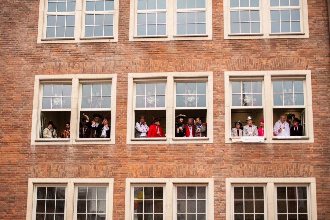 Carnival-goers watch the annual Rose Monday parade in Dussledorf, Germany, on Feb. 16, 2026. Rose Monday is the highlight of Carnival season, especially in western Germany, where float designers are famous for often searing and irreverent depictions of German and foreign politicians. (Hesham Elsherif/Getty Images)