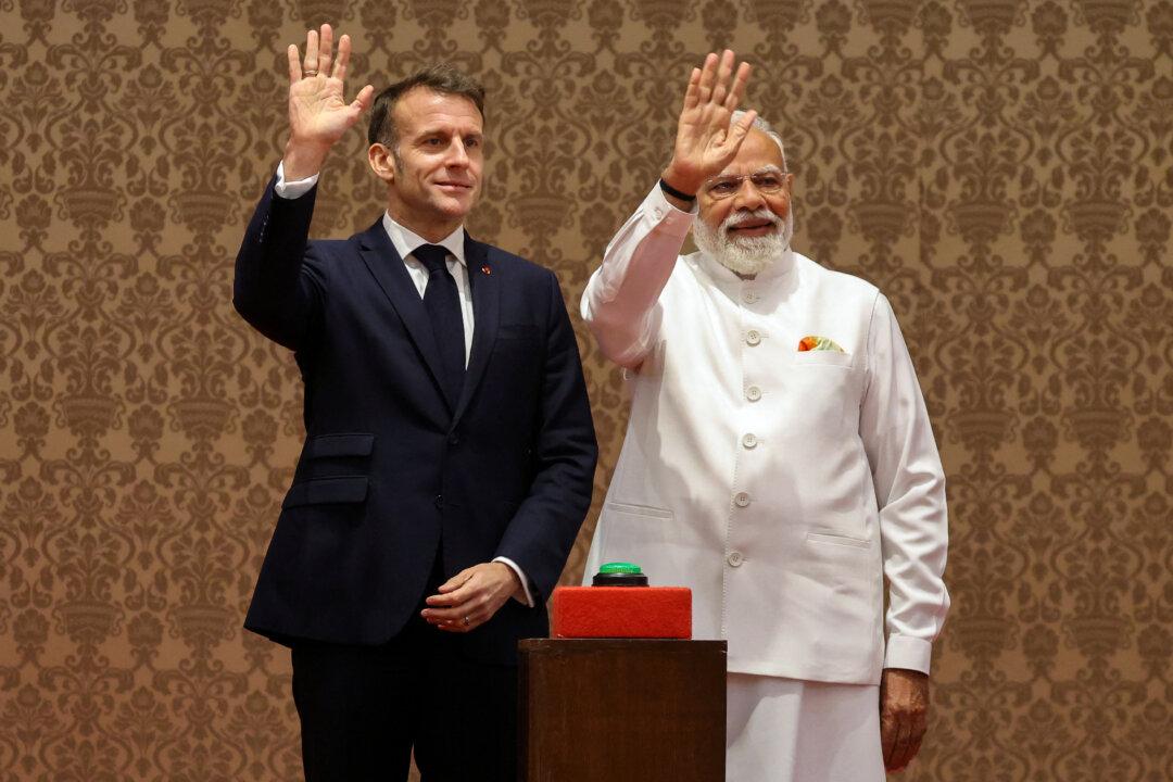 France's President Emmanuel Macron and India's Prime Minister Narendra Modi wave at a press event to deliver joint declarations in Mumbai, India, on Feb. 17, 2026. (Ludovic Marin/AFP via Getty Images)