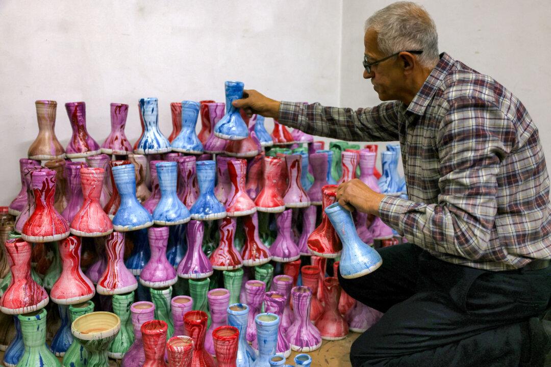 Palestinian instrument-maker Ayyub al-Zaatari arranges miniature darbuka drum instruments at his workshop in the West Bank city of Hebron, on Feb. 17, 2026, to be used as part of an ensemble to wake up Muslim devotees at night for the pre-dawn evening Suhur meal during the holy fasting month of Ramadan, set to begin later in the week. (Hazem Bader/AFP via Getty Images)