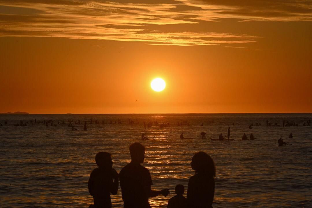 People on stand-up paddles watch the sunrise at Copacabana beach in Rio de Janeiro, on Feb. 17, 2026. (Mauro Pimentel/AFP via Getty Images)