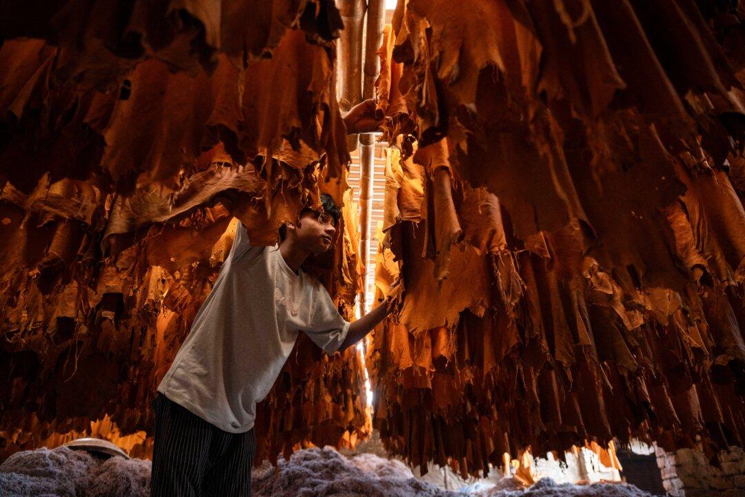 A laborer inspects leather at a tannery in Dhaka, Bangladesh, on Feb. 17, 2026. (Mohd Rasfan/AFP via Getty Images)