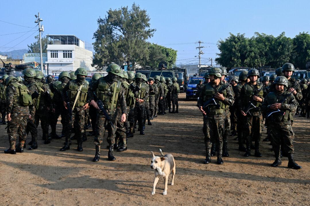 A dog walks amid Guatemalan soldiers during the inauguration of the Sentinel Plan in the Alamedas neighborhood in Guatemala City, on Feb. 17, 2026. (Johan Ordonez/AFP via Getty Images)