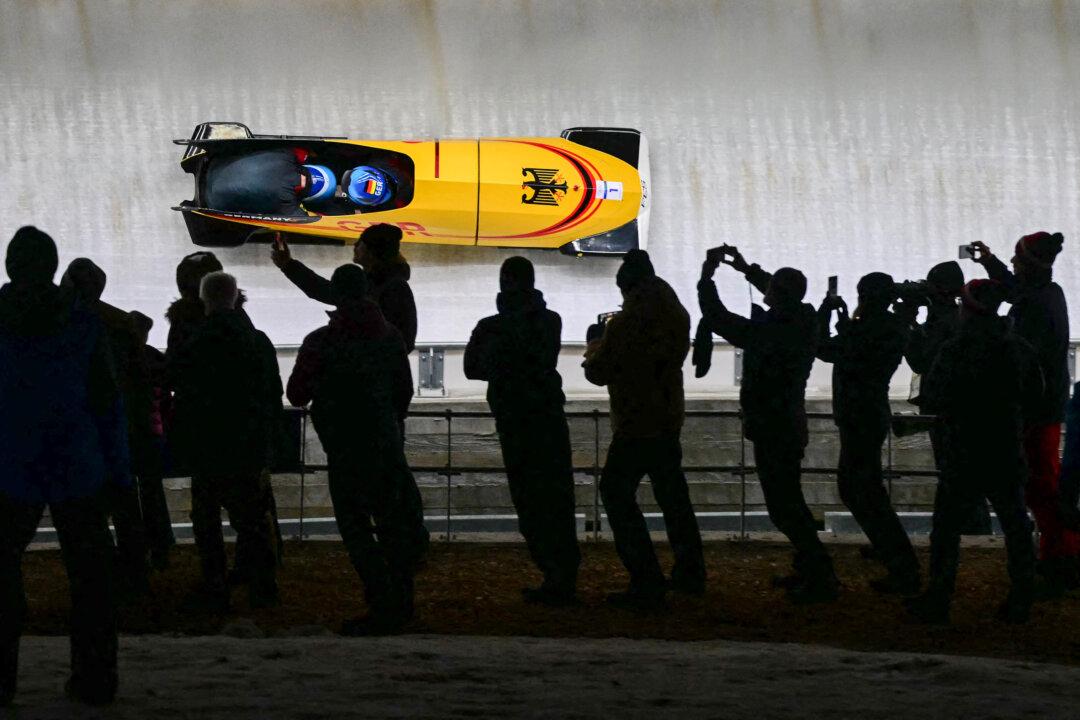 Germany's Johannes Lochner and Germany's Georg Fleischhauer compete in the bobsleigh men's two-man, heat three at Cortina Sliding Center during the Milan Cortina 2026 Winter Olympics in Cortina d'Ampezzo, Italy, on Feb. 17, 2026. (Stefano Rellandini/AFP via Getty Images)