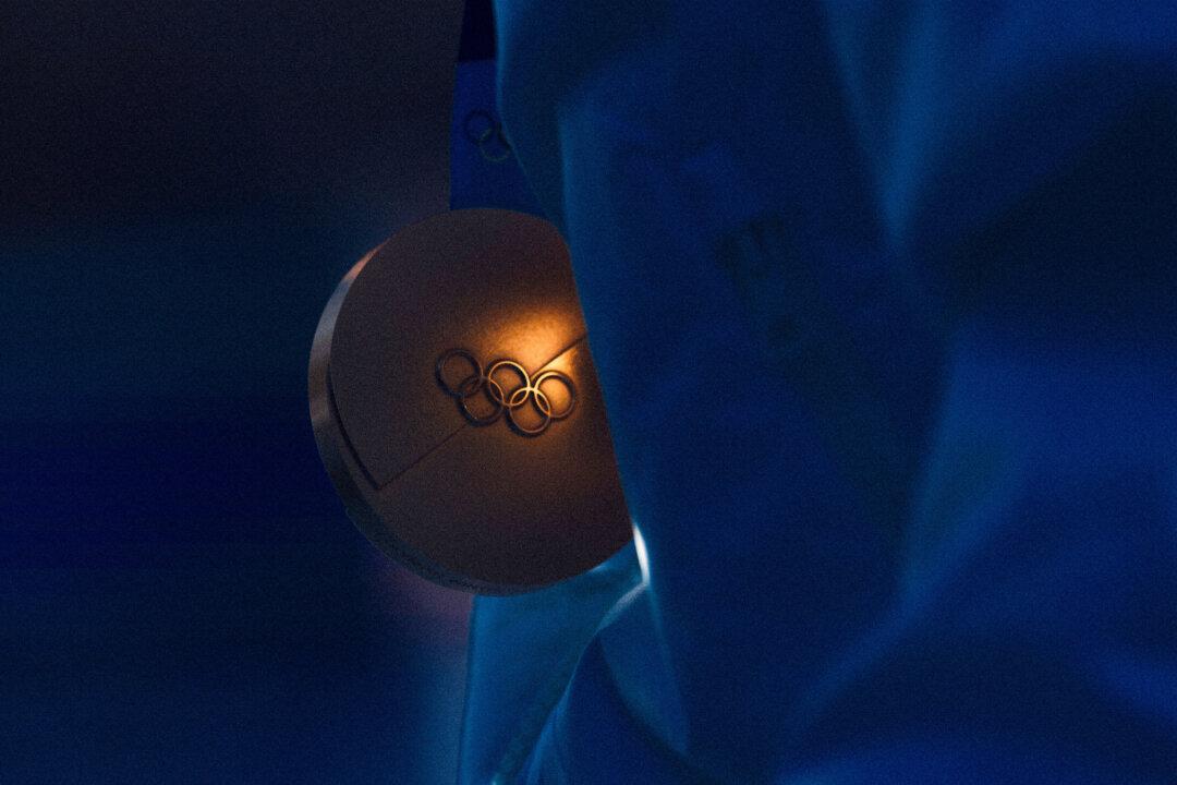 A close-up of a gold medal held by Federica Brignone of Team Italy during the medal ceremony for the Women's Giant Slalom on day nine of the Milan Cortina 2026 Winter Olympics at Tofane Alpine Skiing Center in Cortina d'Ampezzo, Italy, on Feb. 15, 2026. (Mattia Ozbot/Getty Images)