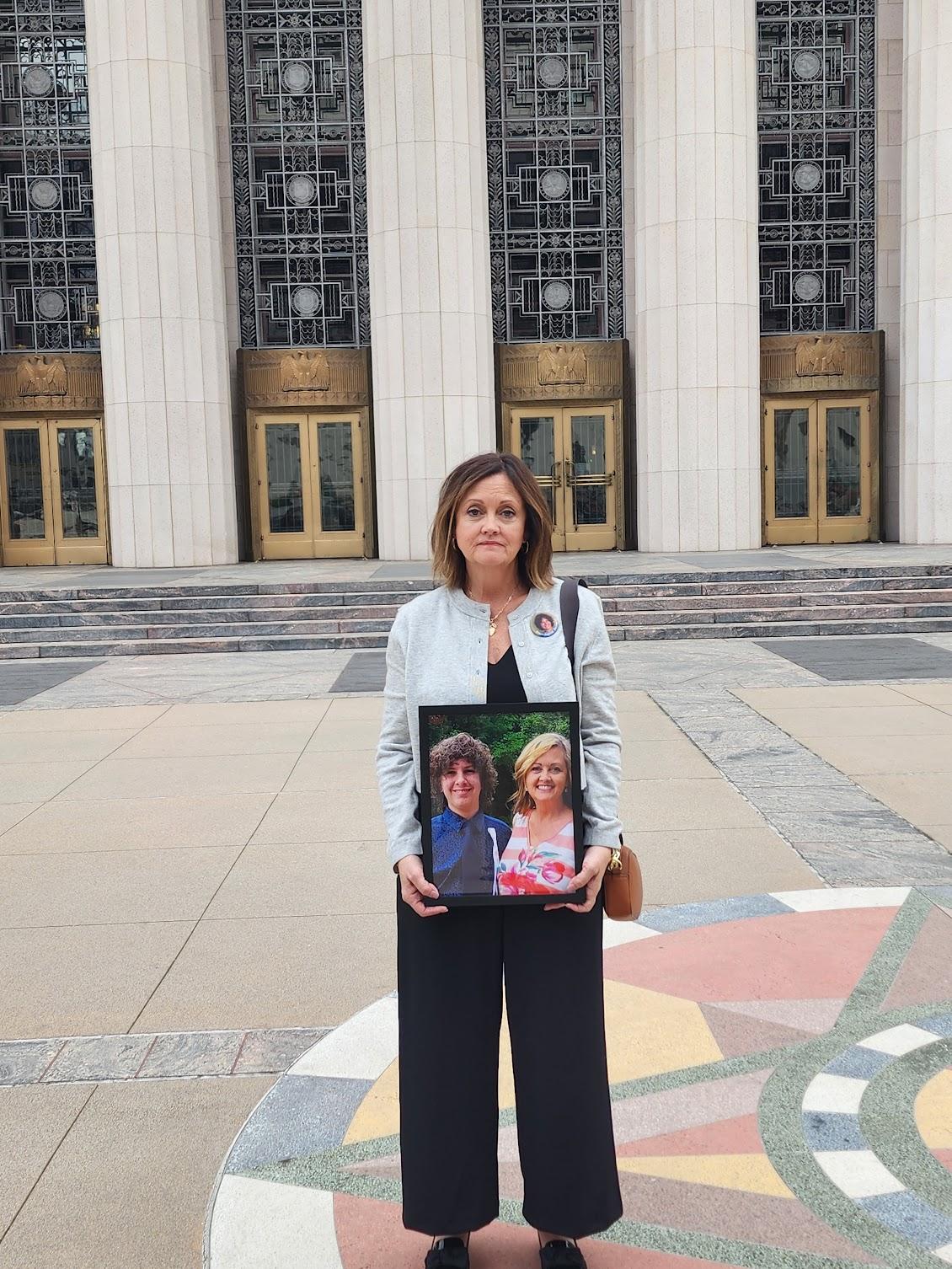 Joann Bogard holds a photo of herself with son Mason at Los Angeles Superior Court on Feb. 5, 2026. Mason died at the age of 15 in 2019 after trying a viral "choking challenge" on YouTube. (Courtesy of Joann Bogard)