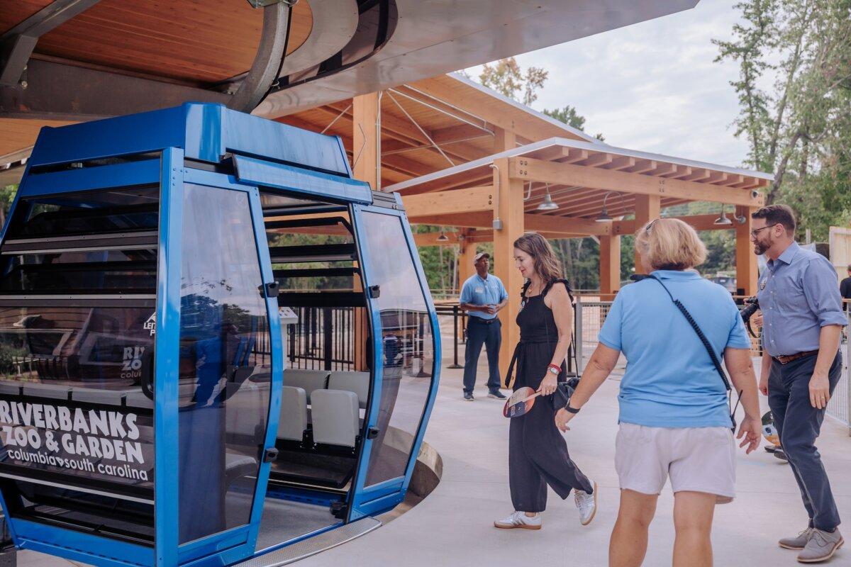 Visitors hop on the Saluda Skyride, an aerial gondola system at Riverbanks Zoo & Garden that goes across the Saluda River, offering a view of the city and surrounding areas. (Courtesy of Riverbanks Zoo & Garden)