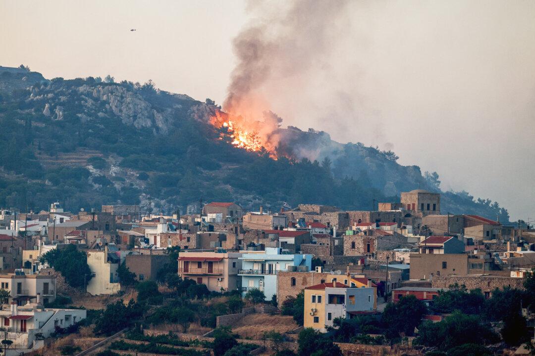 A wildfire moves toward the village of Ágios Geórgios Sykoúsis on the island of Chios, Greece, on June 23, 2025. The blaze burned nearly 30,000 acres of land in northern Chios, much of it overlapping with a proposed antimony industrial zone. (Dimitris Tosidis/AFP via Getty Images)