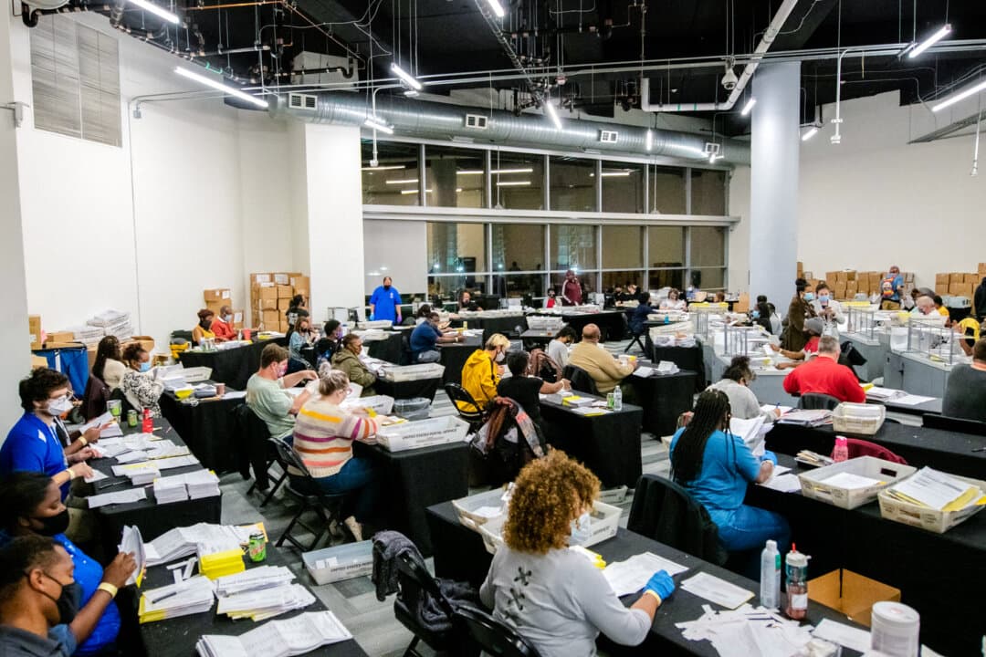 Employees of the Fulton County Board of Registration and Elections process ballots in Atlanta on Nov. 4, 2020. Vote counting in Georgia starts, by law, on Election Day. Fulton County had more than half a million ballots to tabulate—almost 90 percent cast early or by mail. (Brandon Bell/Reuters)