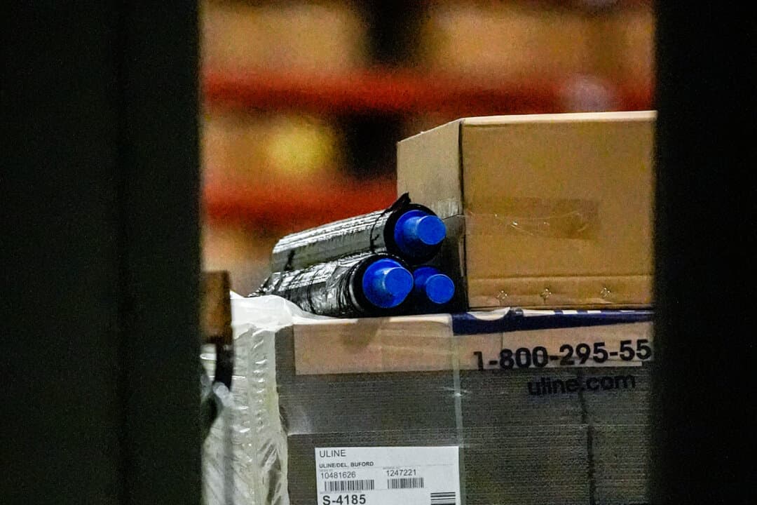 (Left) Equipment is loaded into a truck inside the Fulton County Election Hub as the FBI takes Fulton County’s 2020 election ballots in Union City, Ga., on Jan. 28, 2026. (Right) An FBI employee stands inside the Fulton County Election Hub as the FBI takes Fulton County’s 2020 election ballots in Union City, Ga., on Jan. 28, 2026. (Mike Stewart/AP Photo)