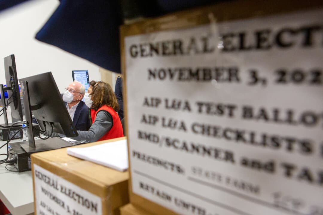 Members of an adjudication review panel examine scanned absentee ballots at the Fulton County Election Preparation Center in Atlanta on Nov. 4, 2020. Because the race was too close, on Nov. 11, 2020, Georgia Secretary of State Brad Raffensperger announced a risk-limiting audit requiring a full hand recount under state law. (Jessica McGowan/Getty Images)