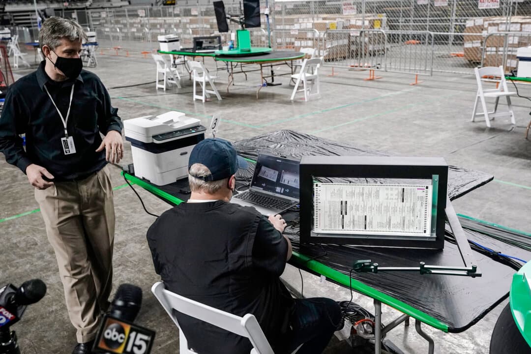 Cyber Ninjas CEO Doug Logan (L), whose Florida-based consultancy oversaw a 2020 election ballot audit ordered by the Arizona Senate, speaks at the Arizona Veterans Memorial Coliseum in Phoenix on April 22, 2021. (Ross D. Franklin/AP Photo)