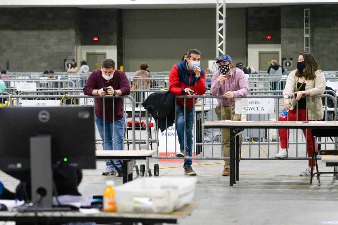 Observers watch as election officials count votes for Fulton County in Atlanta on Jan. 6, 2021. (Megan Varner/Getty Images)