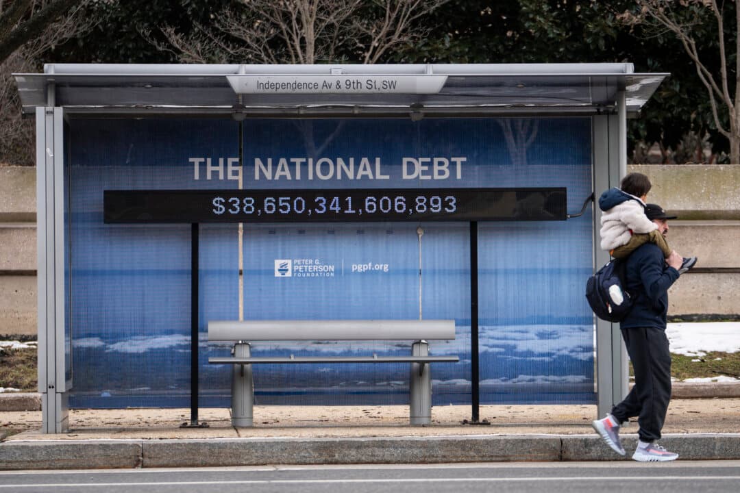 The National Debt Clock is displayed on a bus stop in Washington, on Feb. 17, 2026. Rising national debt is among the economic challenges America faces today. (Madalina Kilroy/The Epoch Times)