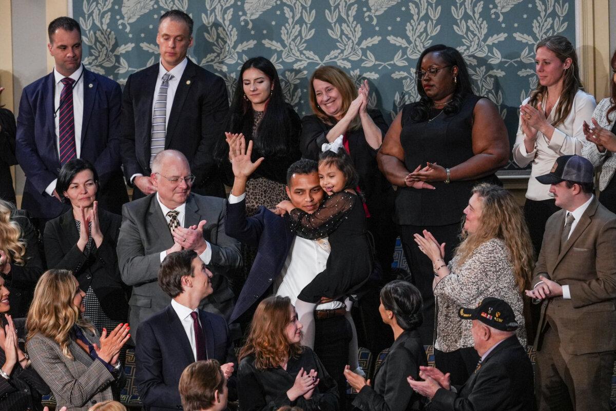 Marcus Coleman and his daughter Dalilah Coleman attend President Donald Trump's first State of the Union address during his second presidential term, in the House Chamber on Capitol Hill in Washington on Feb. 24, 2026. (Madalina Kilroy/The Epoch Times)