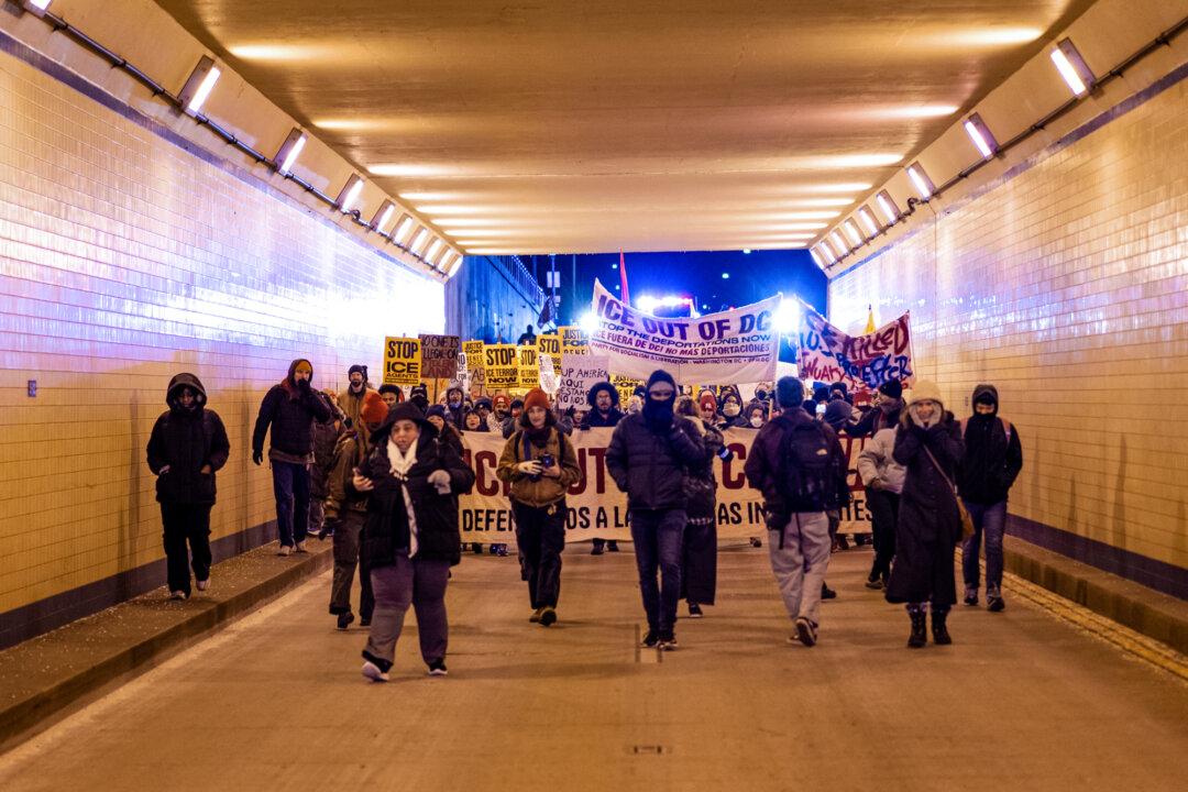 People join a march to protest against Immigration and Customs Enforcement operations in Washington on Jan. 20, 2026. (Madalina Kilroy/The Epoch Times)