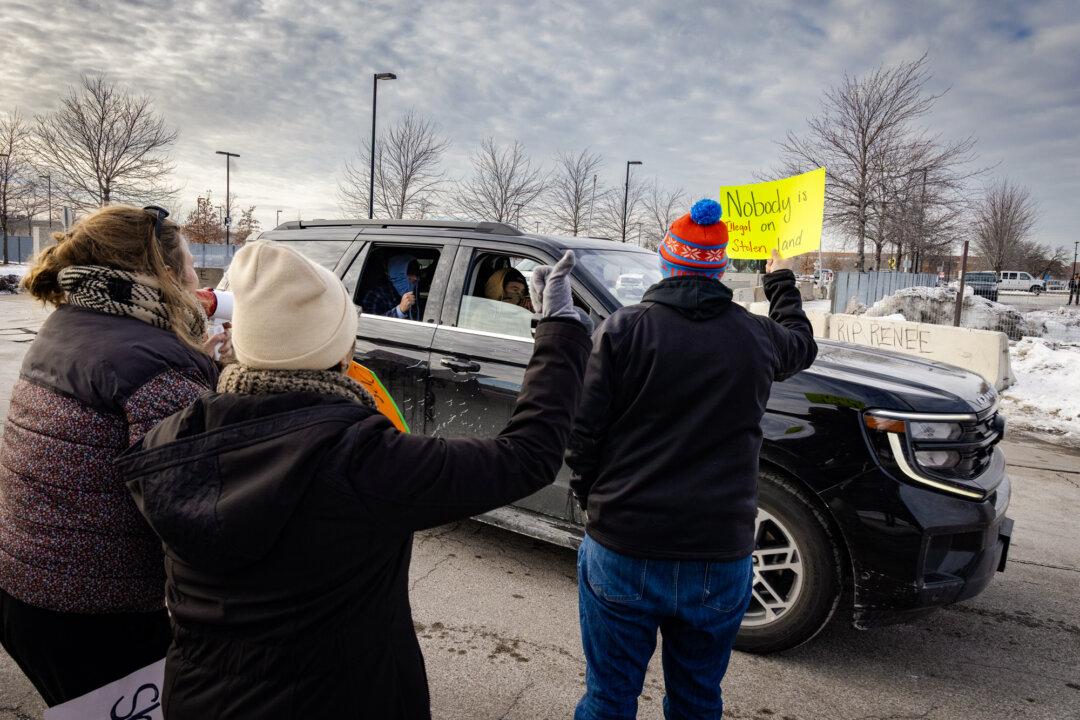 Protestors taunt federal officers in front of the Bishop Henry Whipple Federal Building in Minneapolis on Jan. 11, 2026. (John Fredricks/The Epoch Times)