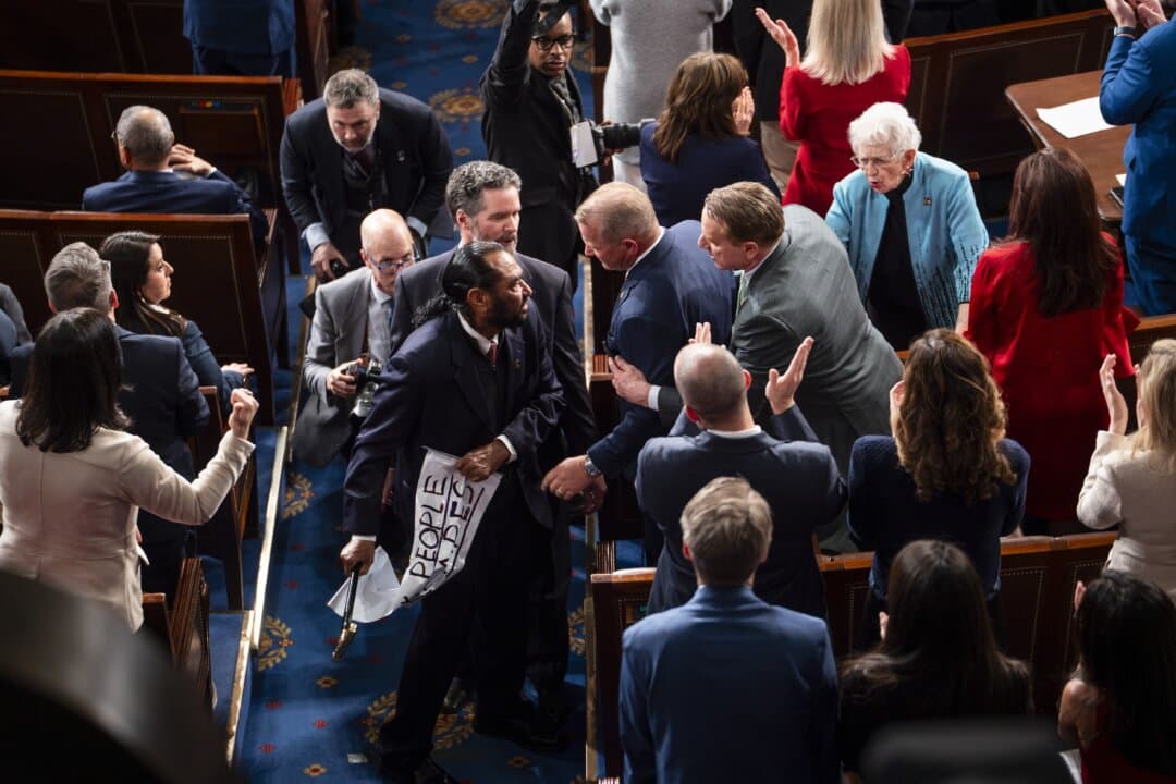 Rep. Al Green (D-Texas) is escorted out of the House Chamber. (Madalina Kilroy/The Epoch Times)