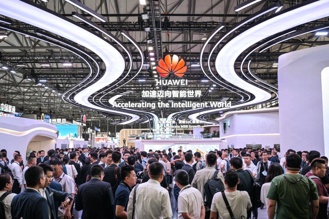 People visit Huawei's stand during the Mobile World Congress at the Shanghai New International Expo Center in Shanghai on June 18, 2025. (Hector Retamal/AFP via Getty Images)