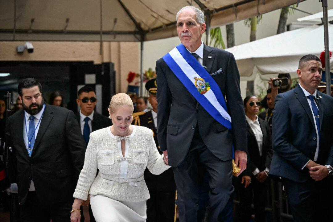 Honduran President Nasry Asfura and his wife, Lissette del Cid, walk onto a stage following the inauguration ceremony at the Honduran Congress, in Tegucigalpa, Honduras, on Jan. 27, 2026. (Johan Ordonez / AFP via Getty Images)