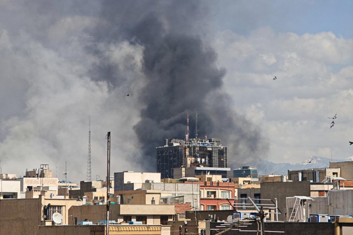 Plumes of smoke rise over the skyline following explosions in Tehran, Iran, on March 1, 2026. (Majid Saeedi/Getty Images)